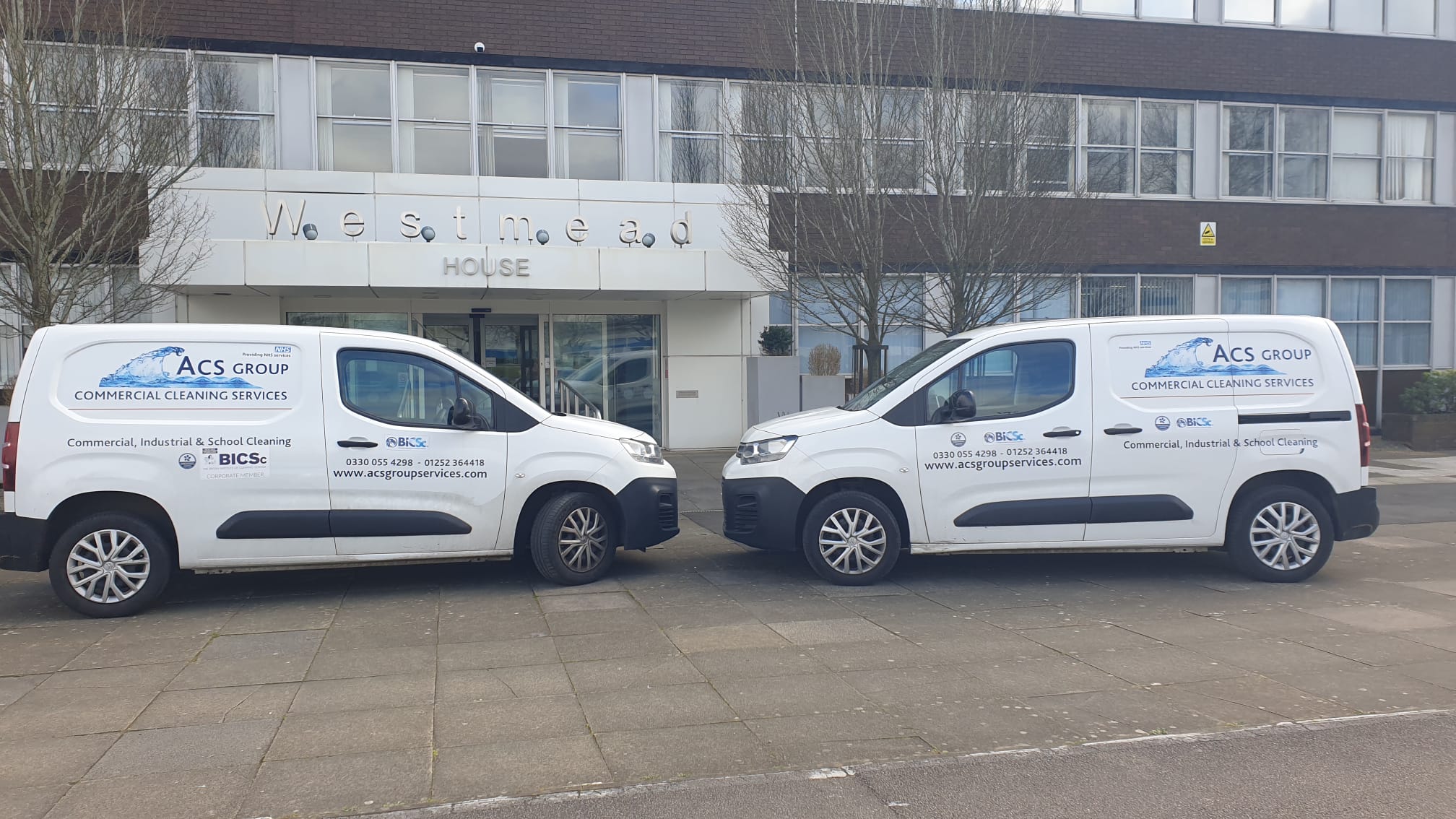 ACS branded vans parked outside head office