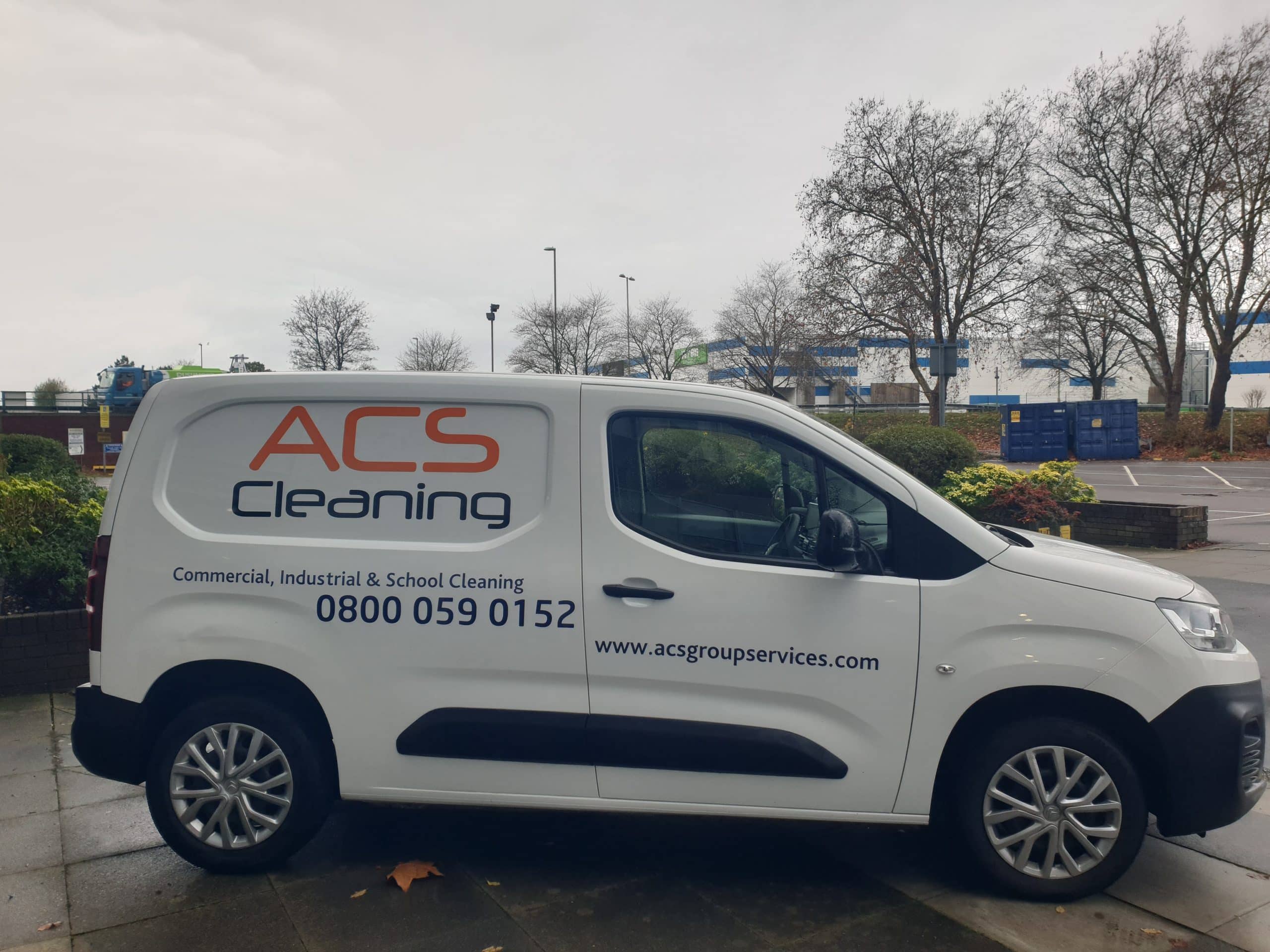 A white van with a company name on it.